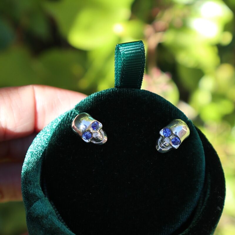 Hand made skull cufflinks made in sterling silver with natural blue sapphire eyes