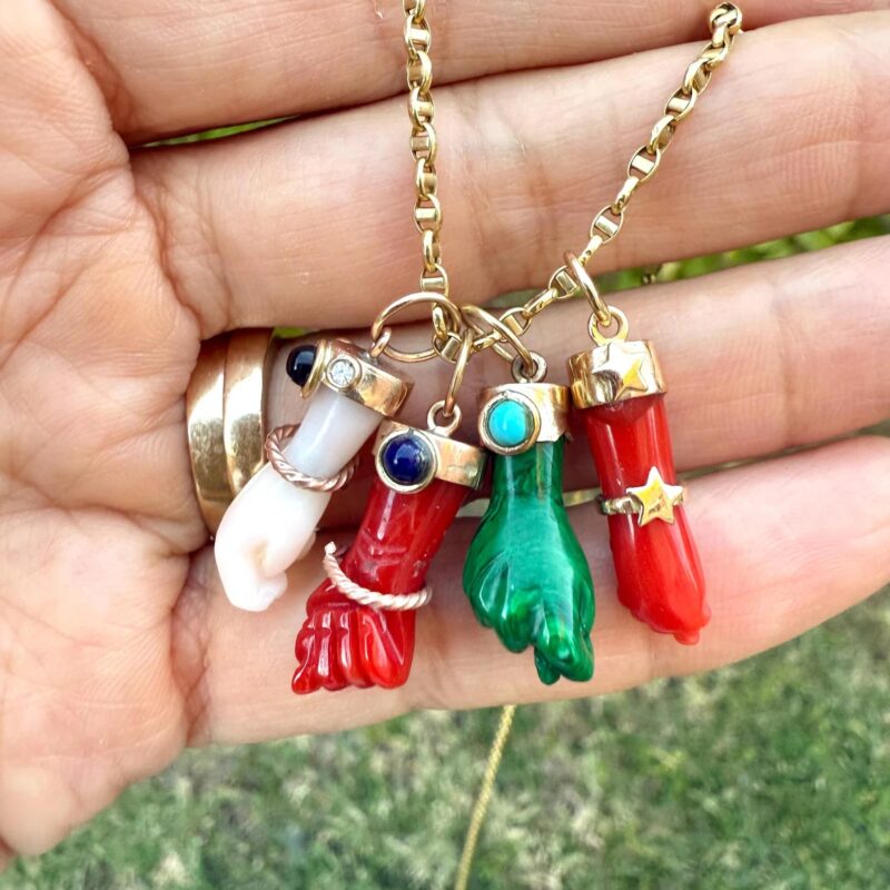 Italian "figa" hand pendants made of natural coral, malachite, and 14K gold.